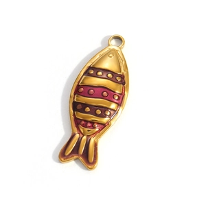 Detailed close-up of a fish-shaped gold-plated pendant with red and gold enamel stripes
