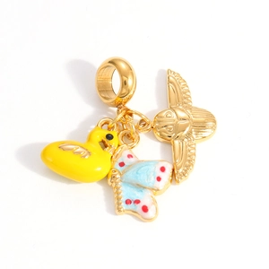 Detail of gold charms with yellow duck and blue butterfly enamel for jewelry making