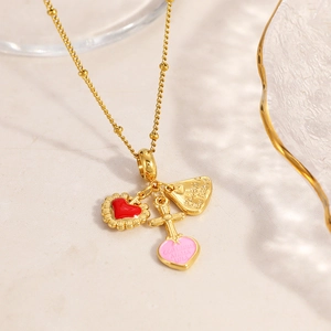 Gold stainless steel beaded necklace with red heart, cross, and pink enamel charms