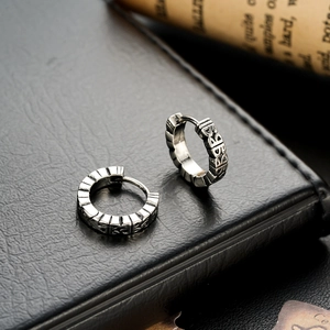 Vintage punk hoop earrings in blackened steel finish with embossed letter pattern