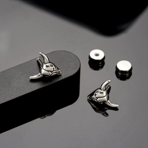 Polished silver bull head stud earrings in stainless steel with a sleek industrial design