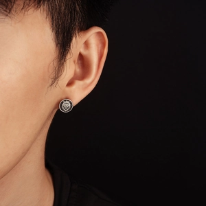 Macro detail of vintage lion head stud earring with crown engraving and matte finish