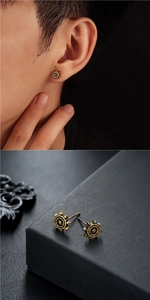 Detail view of retro ship wheel stud earrings with vintage gold textured finish for men