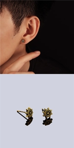 Macro detail of retro bronze rudder stud earrings with punk industrial gear design