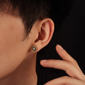 Golden Eye of Horus stud earring with clear stone and black geometric engraving
