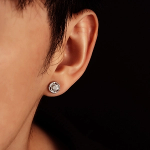 Silver barbell stud earring with central zircon and engraved detail on male model
