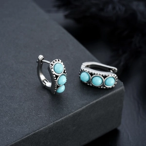 Vintage silver huggie earrings with three inlaid turquoise beads and ethnic carving