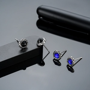 Mens round cubic zirconia stud earrings in black and blue stones with textured silver base