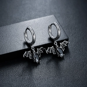 Macro shot of gothic bat earrings with vintage silver finish and black faceted gems