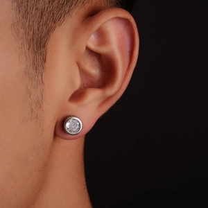 Macro shot of men's silver stud earring featuring a brilliant round-cut zircon stone