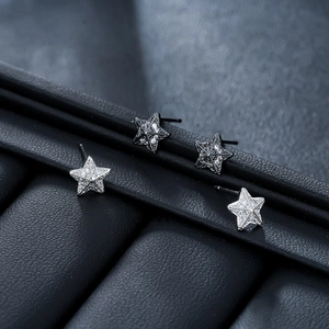 3D star stud earrings in silver and black metal with sparkling micro-pave crystals