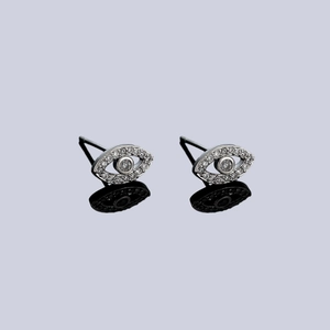 Evil eye stud earrings with sparkling silver pavé zircons on a black reflective surface