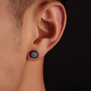 Macro view of men's evil eye stud earring with blue and black pavé zircon stones