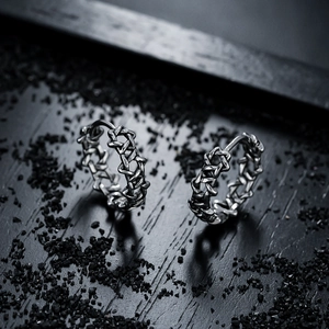 Close-up of hollow hexagram hoop earrings with vintage oxidized silver finish for men