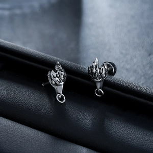 Macro detail of silver eagle head stud earrings with vintage hip-hop metallic texture