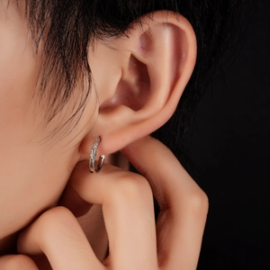 Silver hoop earring with vintage geometric patterns for men and women on dark background