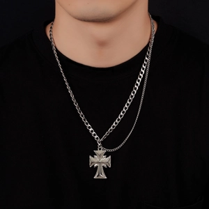 Close-up of a double-layered stainless steel cuban chain necklace with a cross pendant for men