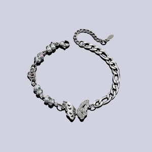 Detail of a butterfly charm bracelet with crystal beads and stainless steel Figaro chain