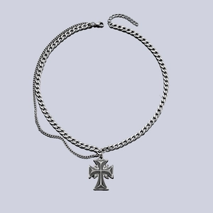 Detailed macro shot of vintage silver cross pendant with chunky Cuban link chain and lobster clasp