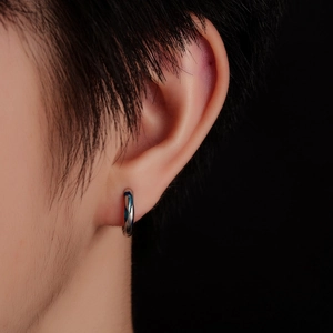Minimalist blue wave pattern hoop earring on model ear with high gloss metal finish