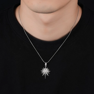 Silver north star pendant with cubic zirconia on a snake chain worn by a model