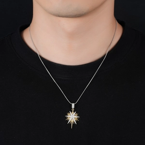 Detail of starburst pendant with gold and silver rays set with white zircon stones