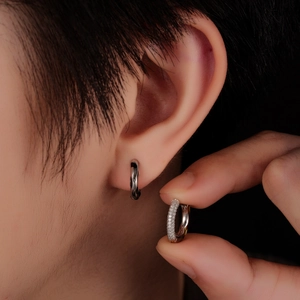 Detailed view of silver hoop earrings with one minimalist band and one full pavé style