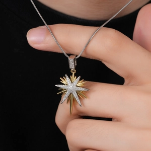 Starbust pendant necklace in gold and silver finish with zircon stones on a snake chain