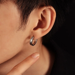 Minimalist silver hoop earrings with sleek black stripes and carved textures for men