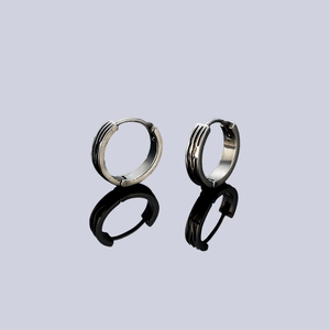 Stainless steel huggie earrings with black striped design and mirror reflection