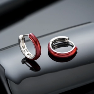 Men's silver huggie hoop earrings with deep red enamel finish and polished metal shine