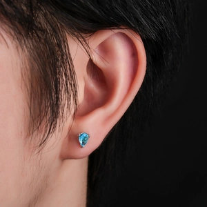 Blue pear-cut zircon stud earrings in 925 silver setting worn by a female model