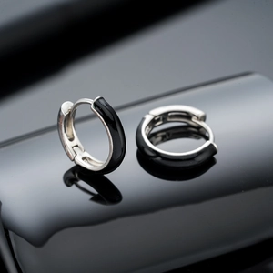 Modern silver hoop earrings with black enamel inlay and flexible snap closure