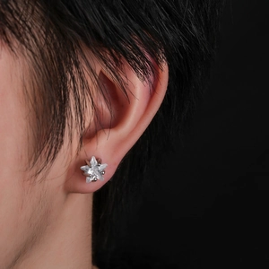 Star-shaped stud earring with five-pointed zircon stone shown on a model's ear lobe