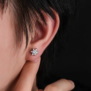 Sparkling silver snowflake stud earrings with micro-pushed zircon on ear model