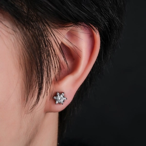 Detailed view of a micro-set snowflake earring with black plating and sparkling zircons