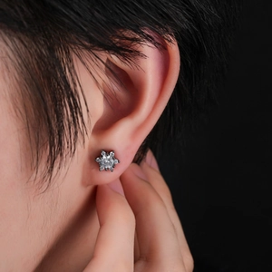 Close-up of snowflake stud earrings with black metal and micro-pave white zircon stones