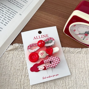 Detailed set of three red and white checkered hair clips with bow and heart button accents