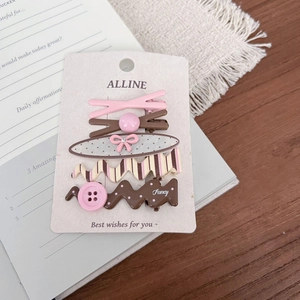 Detailed set of 5 vintage plaid and polka dot hair clips on a presentation card
