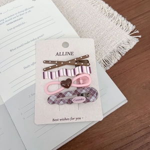 Detailed set of four vintage plaid and polka dot hair clips on a branded display card