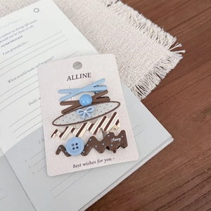Five-piece blue and brown polka dot bow hair clips set on elegant display card
