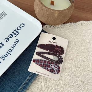 Detailed close-up of retro hair clips set featuring plaid patterns and chic polka dots