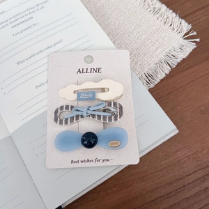 Detailed set of three Korean style hair clips with bows and beads on a paper display card