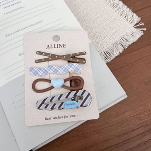 Set of four vintage hair clips with blue polka dots and plaid patterns on beige card