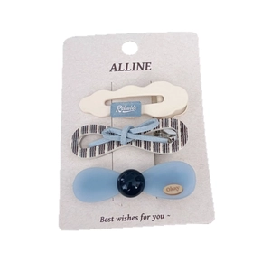Three-piece hair clip set with blue polka dot bow and cloud design on display card