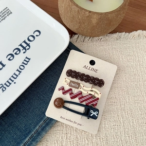 Close-up of a 4-piece vintage hair clip set with wave patterns on a gift display card