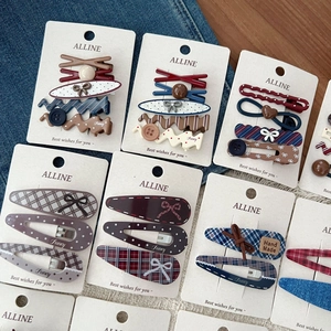 Detailed set of vintage checkered and polka dot hair clips on a branded display card