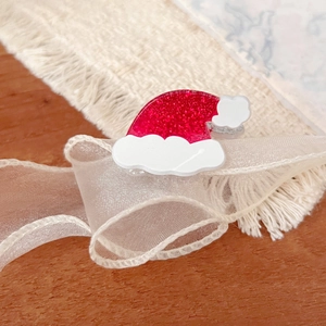 Acrylic Christmas hat hair clip with red glitter finish and festive holiday theme