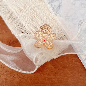 Mini acrylic gingerbread man hair clip with gold glitter and colorful Christmas details