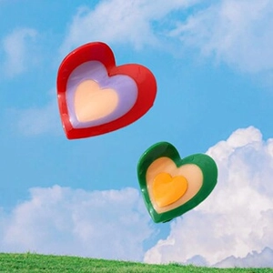Creative floating layered heart hair claws in vibrant red and green resin finishes